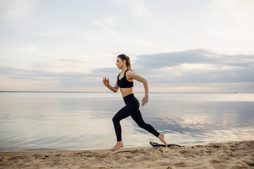 Fototapeta na wymiar Healthy woman running on the beach, girl doing sport outdoor, fitness and heath care concept with copy space over natural background