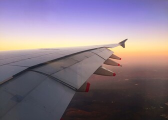 Fototapeta na wymiar aeroplane, wing, plane, outside, fly, sunset, blue sky, travel, beautiful, wallpaper, world, 