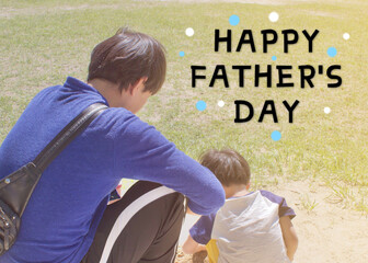  Dad and Son are sitting and doing activities together on the green lawn in the park,happy family and happy father's day concept