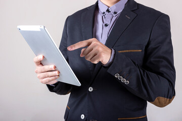 Man in business suit with digital composite using tablet.