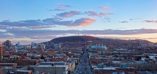 Beautiful high vanilla sky view on Mount Royal and nearby district Plateau above Rachel street and roofs, which goes away into perspective to the mount.