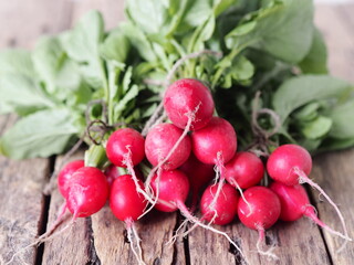 Natural, grown in the garden, freshly ripped radish on a wooden ancient background.