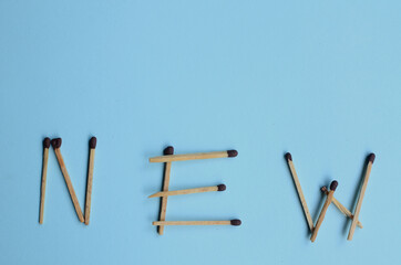 Scattered matches stick on a blue background with copyspace. Top view.
