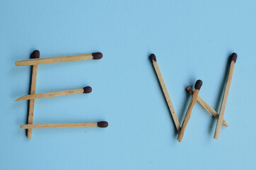 Scattered matches stick on a blue background with copyspace. Top view.
