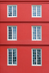 Six white windows wooden on a red wall