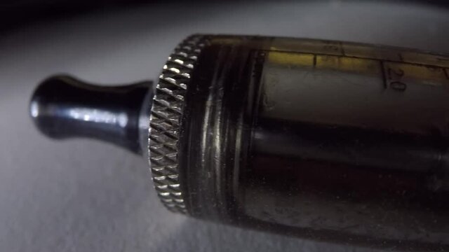 Vape pen with a used empty container close up with a macro lens.