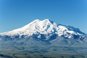 snow covered mountains. Elbrus, mountains in summer.