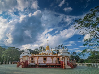 Fototapeta premium view of white pagoda with cloudy sky background, Mara Chena Chedi, Wat Fa Weangin, side by side Lak Tang border Pass, Wiang Hang District, Chiang Mai, northern of Thailand..