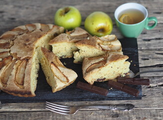 Homemade Apple pie on a rustic wooden background. A classic dessert made of dough for any holiday.