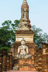 Fototapeta premium Old Buddhist temple Wat Traphang Ngoen with a sitting Buddha statue, ancient ruin city Sukhothai, Thailand