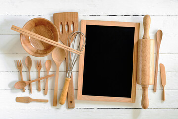 Overhead view of wood utensils and chalkboard on wood board background