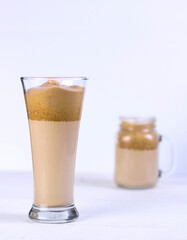 Two dalgona coffee in glass on white table