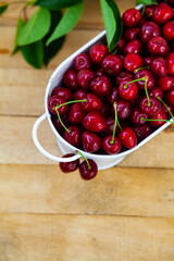 Ripe sweet cherries on a wooden background.