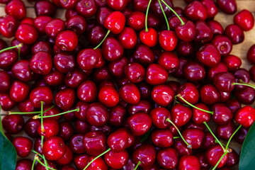 Ripe sweet cherries on a wooden background.