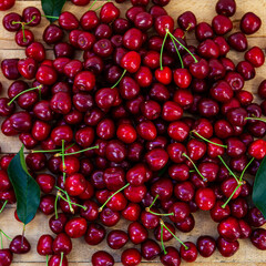 Ripe sweet cherries on a wooden background.