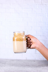 hand holding a glass of milk