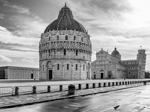 Black and white view of the famous Piazza dei Miracoli square and the leaning tower, in the historic center of Pisa, Italy, completely deserted due to the Covid-19 coronavirus pandemic