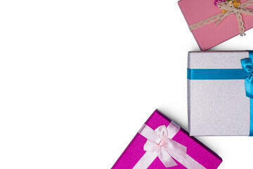top view of gift boxes with ribbons of delicate colors on a white background