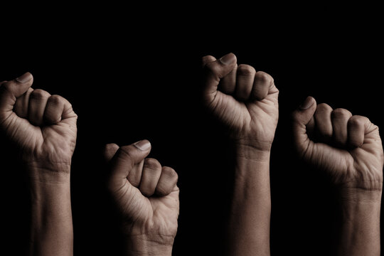Concept against racism or racial discrimination by showing with hand gestures fist or solidarity