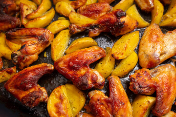 Baked chicken and potatoes in the oven as a background.