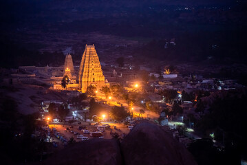 a view of Virupaksha Temple, a famous and ancient Shiva Temple built by Vijayanagara Rulers in 7th Century AD, shot from Mathanga Hill just before sunrise during the blue hour