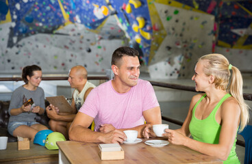 Couple drinking coffee at bouldering gym
