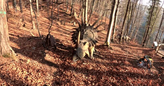 Dinosaur in the forest, on a sunny autumn day, in Dino Park Rasnov, Romania