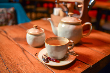White tea set served on a rustic wooden table in a restaurant. Tea time. Ceramic tea set. Eating out concept.