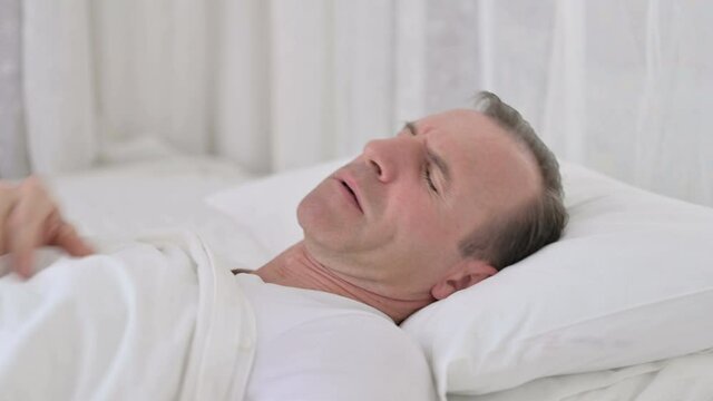 Sick Middle Aged Man Sleeping In Bed And Coughing