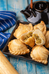 Homemade chicken Curry puffs on wooden table
