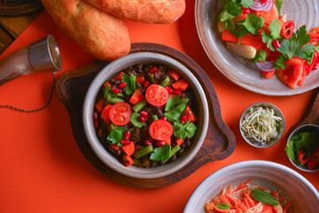 Lenten menu dishes assortment. Different healthy vegetable salads. Bright orange background. Flat lay. Top view.