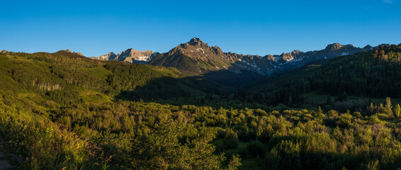 mountain landscape at sunset with clear blue skies