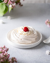 meringue with raspberries on a light background. 