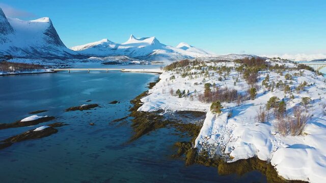 Landscapes of winter Norway. Coast. Ferry. Mountains and fjords in Norway in winter. Panoramic view. Aerial photography. Sunny winter day. Winter card. landscape.