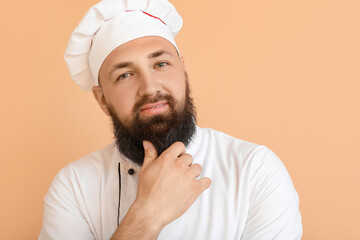 Handsome male chef on color background