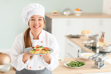 Female chef with tasty dish in kitchen
