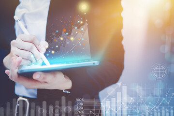 Business women wear suits Hold a laptop with a pen, write a report, display a modern graph in presenting the financial details of the organization