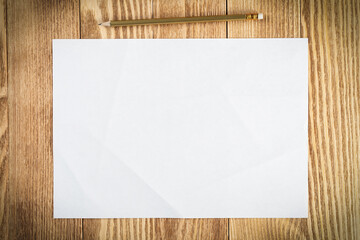 Sheet of paper lying on wooden table