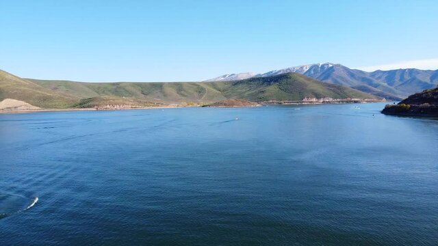 Mountain lake in early summer with smooth water