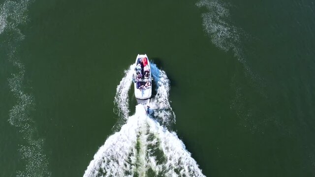Boating and wake surfing on smooth water.