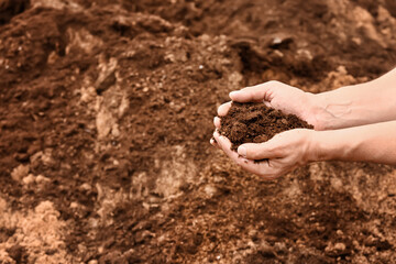 Man testing rich soil outdoors