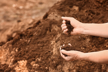 Man testing rich soil outdoors