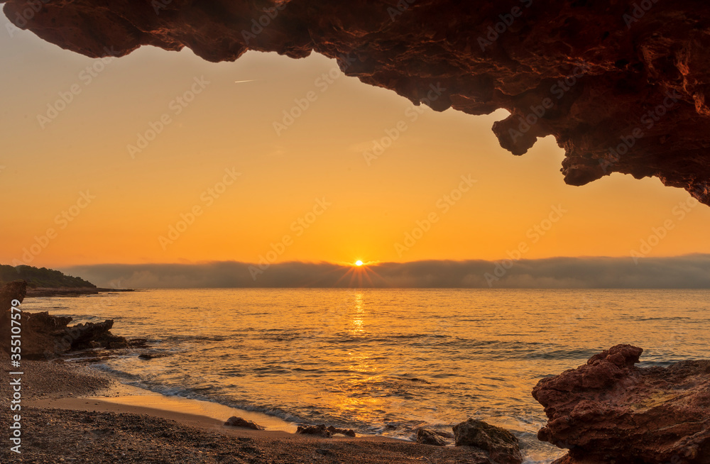 Wall mural the coast of oropesa from the sea at sunrise