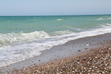 sea coast with a foam wave, summer vacation.