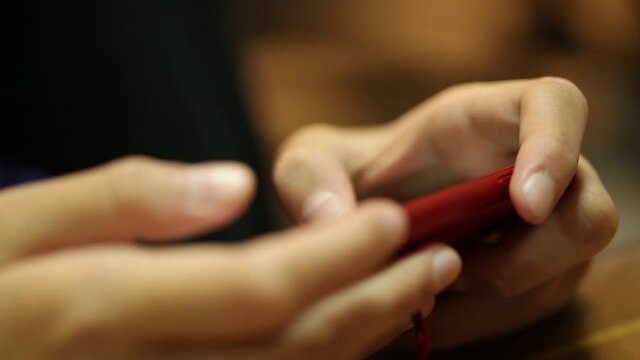 People hand using smartphone device closeup macro blur background