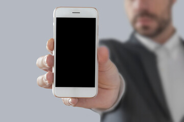 Businessman showing smart phone, with copy space