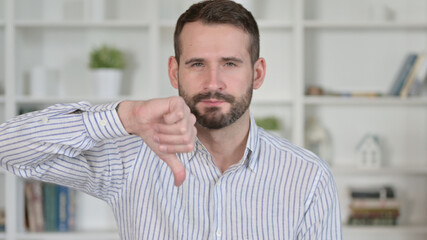 Portrait of Young Man showing Thumbs Down