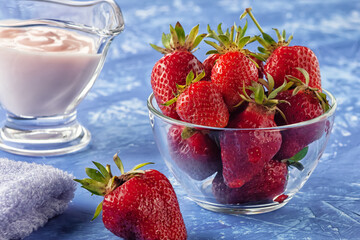 Fresh strawberries with freshly prepared yogurt on the table
