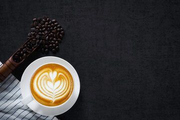 Top-down hot latte coffee cup and beans with copy space for text.