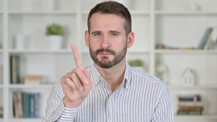 Obraz premium Portrait of Young Man saying No with Finger Sign